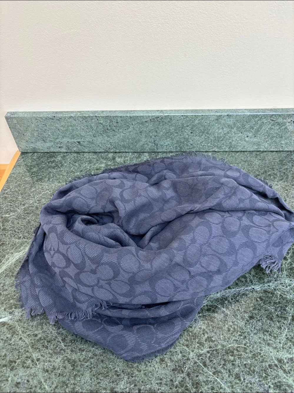 Coach Signature Wrap  made from a wool and silk blend with a tonal jacquard logo